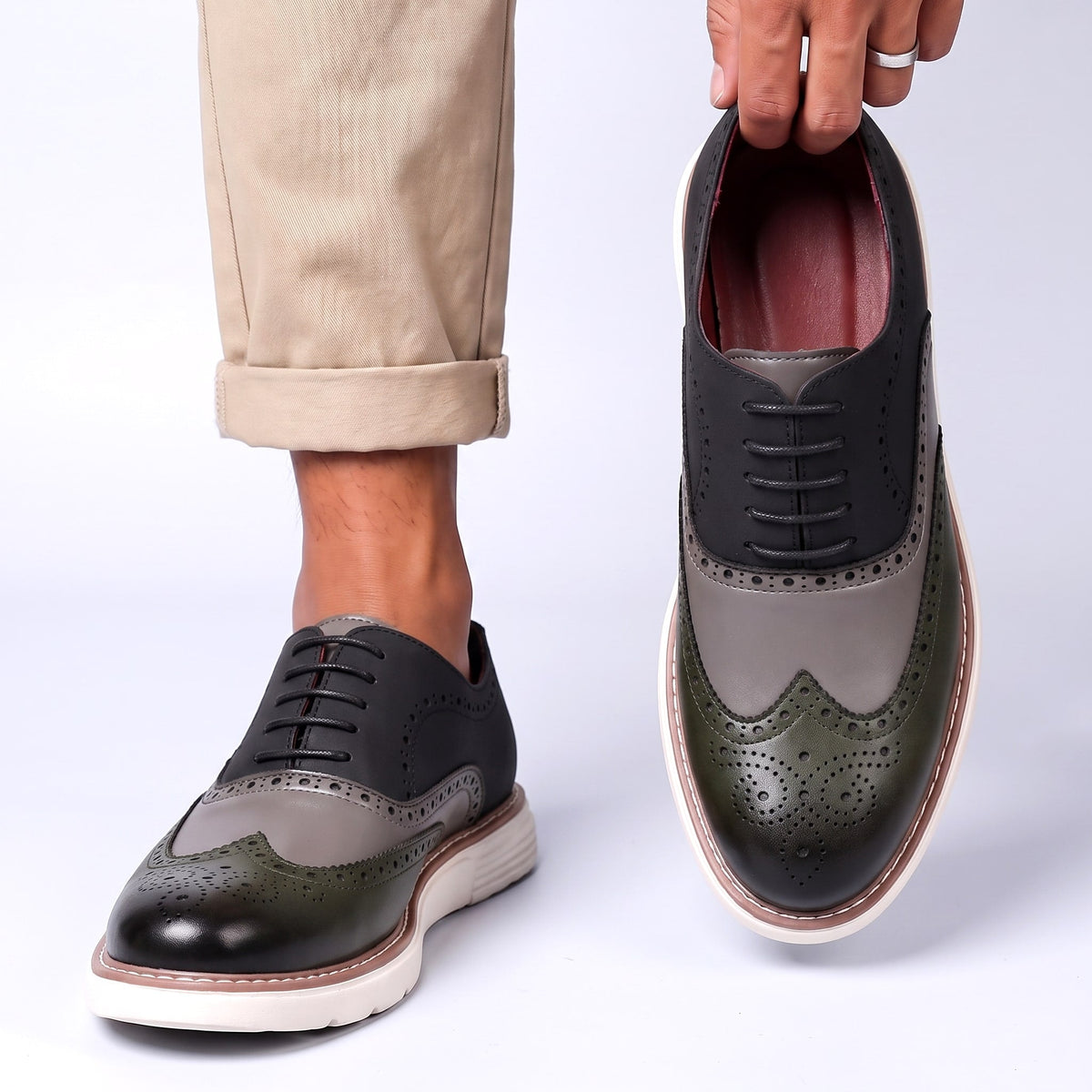 Men's Faux Leather Two-Tone Wingtip Brogue Shoes in Gray – worn and held front view | Hensley London