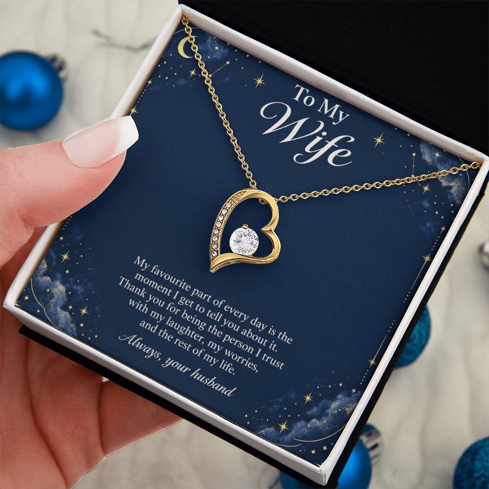 Yellow-gold Forever Love heart necklace and Wife message card in standard box held in hand | Hensley London