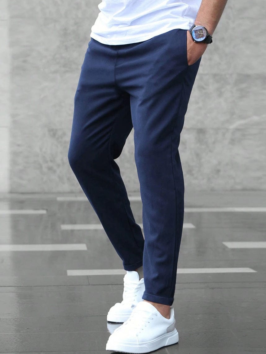Men's Drawstring Tapered Trousers with Elasticated Waist in Dark Blue – front view on model | Hensley London