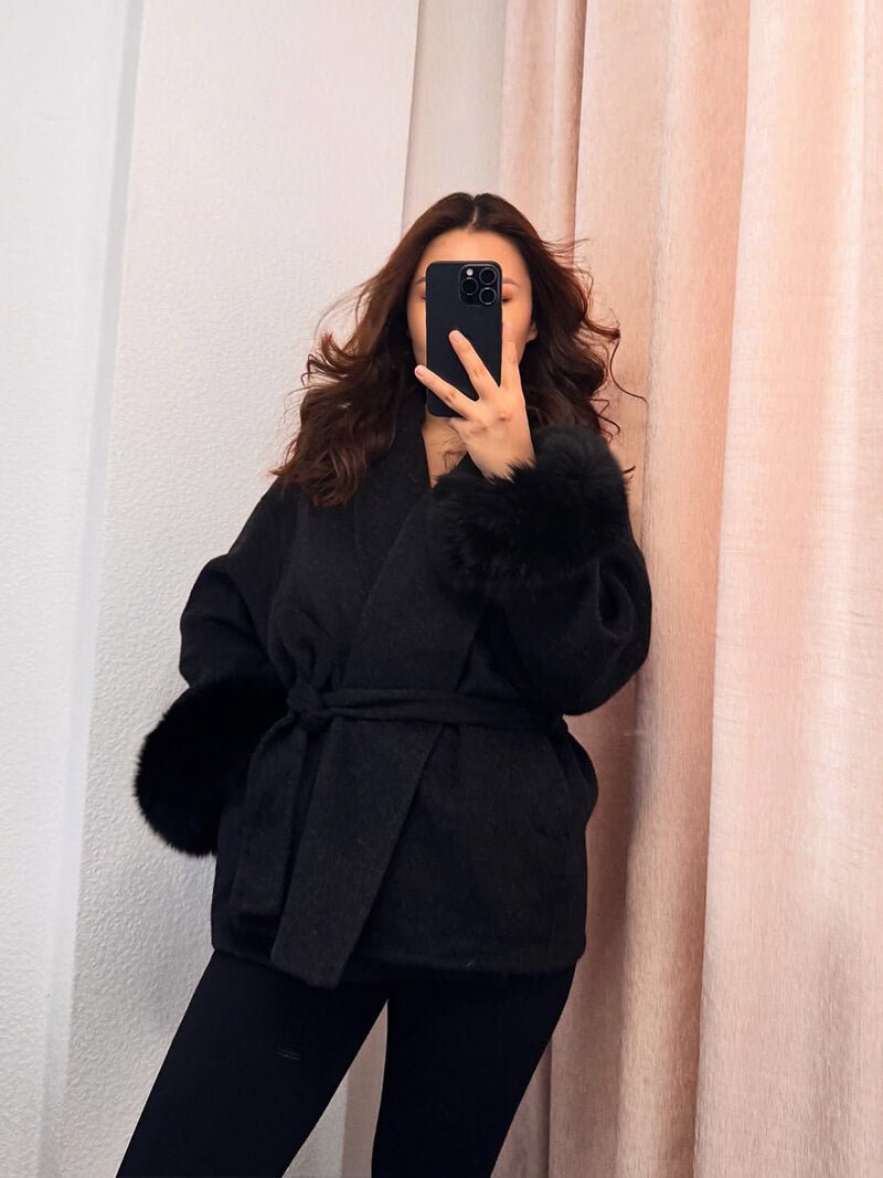 Women's Belted Shawl-Collar Coat with Textured Cuffs in Black – front worn view | Hensley London