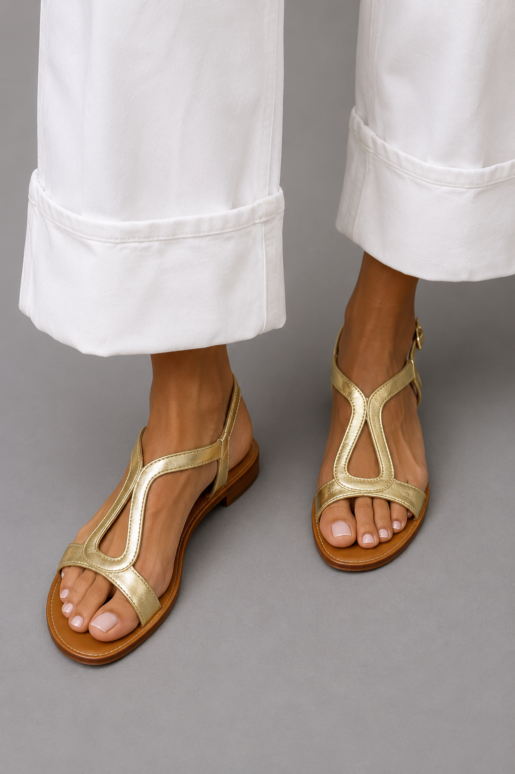 Women's T-Strap Flat Sandals in Gold – front view on feet | Hensley London