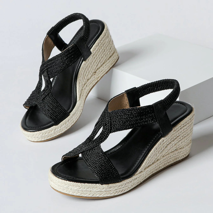Women's Braided Strap Wedge Sandals in Black – pair three-quarter view | Hensley London