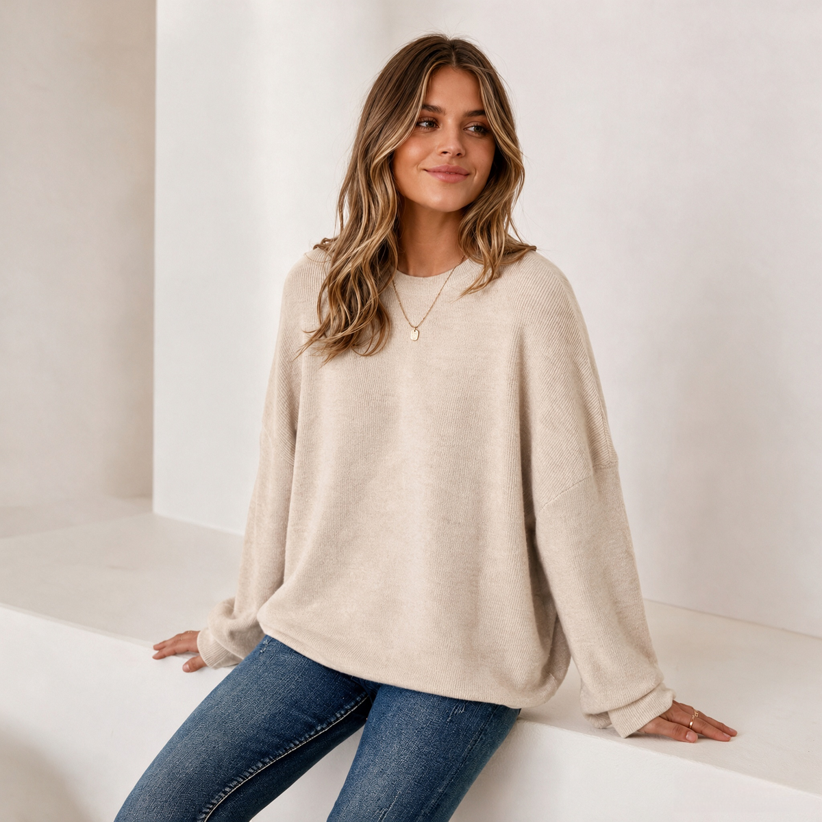 Women's Crew-Neck Knit Jumper in Beige – seated front view | Hensley London