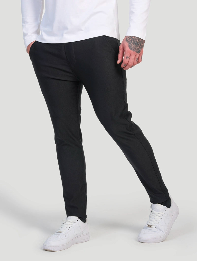 Men's Slim-Fit Stretch Trousers in Black – lifestyle view | Hensley London