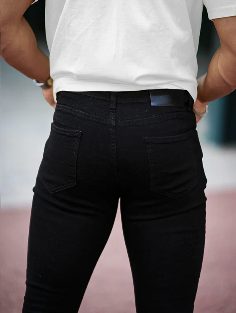Men's Slim Fit Stretch Denim Jeans in Black – styled view | Hensley London