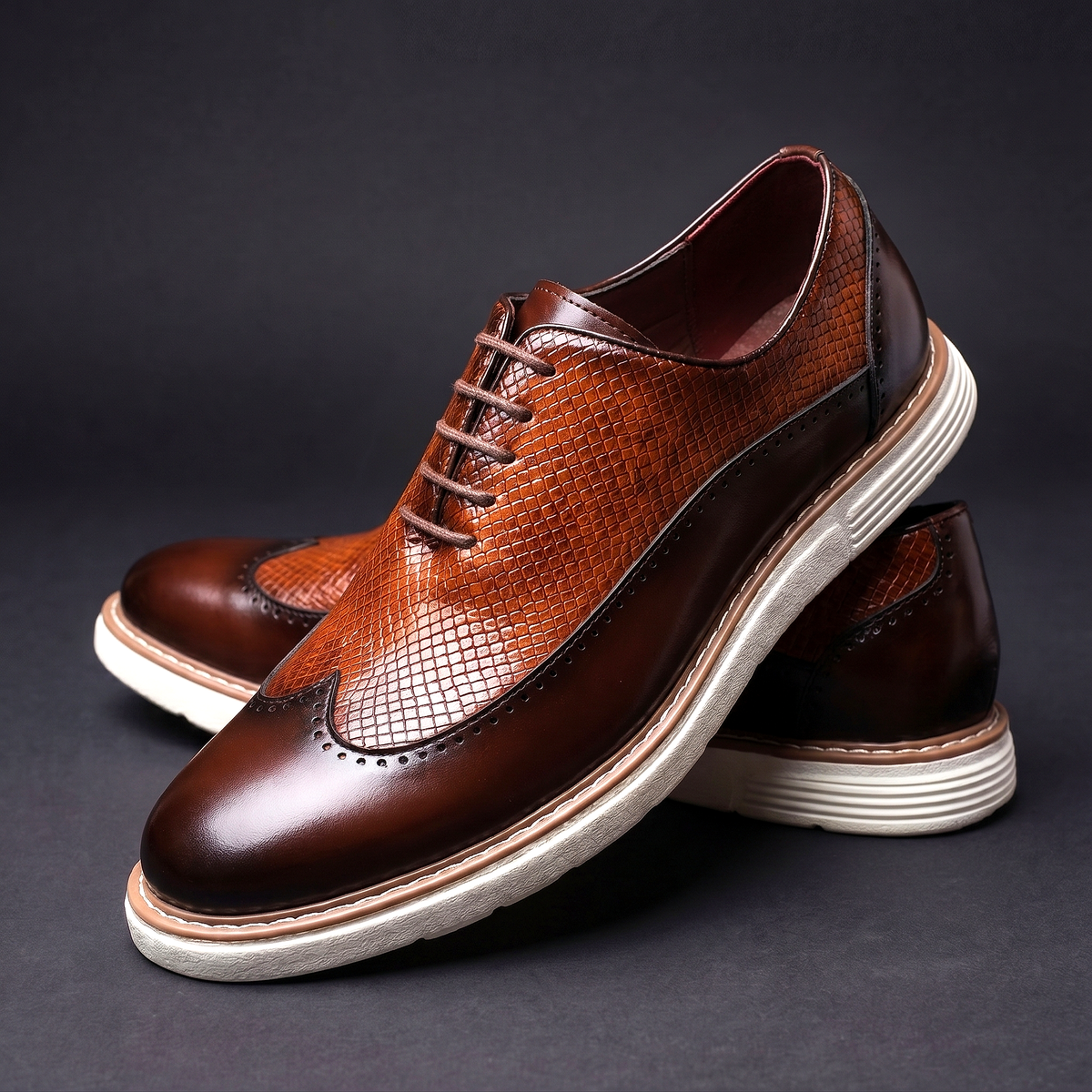 Men's Faux Leather Textured Wingtip Brogue Shoes in Brown – three-quarter stacked pair | Hensley London