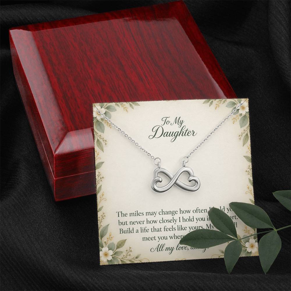 White-gold Endless Love infinity necklace and Daughter message card beside luxury box and foliage | Hensley London