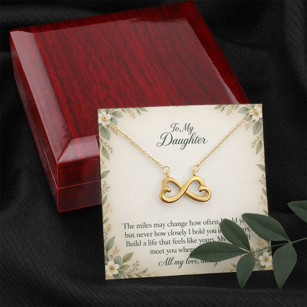 Yellow-gold Endless Love infinity necklace and Daughter message card beside luxury box and foliage | Hensley London
