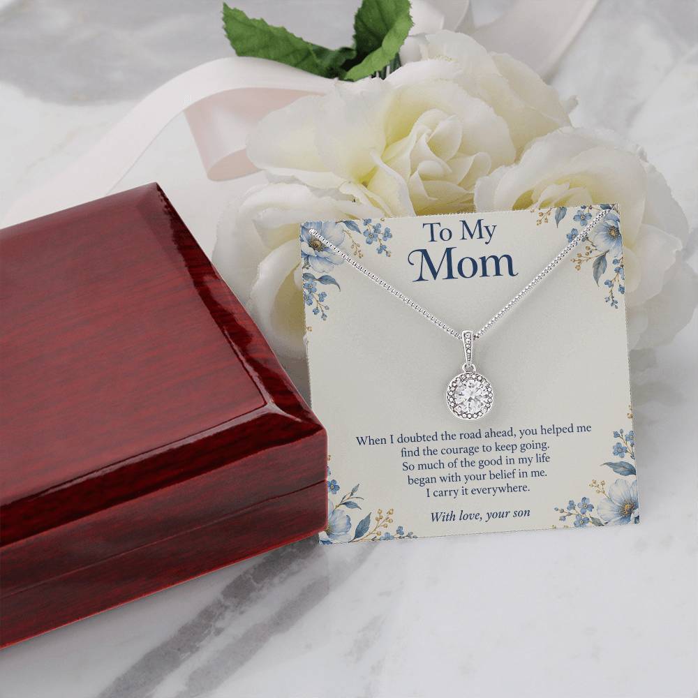 Eternal Hope crystal necklace and Mom message card beside closed luxury box and white flowers | Hensley London