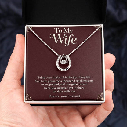 Lucky In Love necklace and Wife message card in standard box held in hand | Hensley London