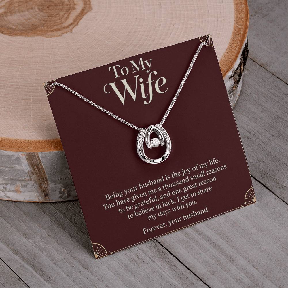 Lucky In Love necklace and Wife message card displayed on a table | Hensley London