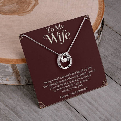 Lucky In Love necklace and Wife message card displayed on a table | Hensley London