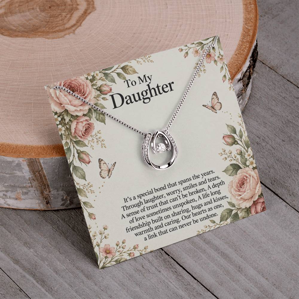 Lucky In Love teardrop necklace in white gold finish – Rose Botanical necklace and message card on wood | Hensley London