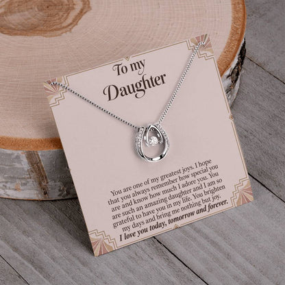 Lucky In Love teardrop necklace in white gold finish – Blush Art Deco necklace and message card on wood | Hensley London