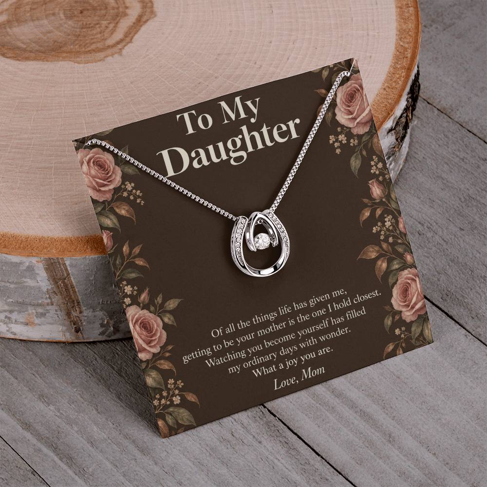 Lucky In Love necklace and Daughter message card displayed on a table | Hensley London