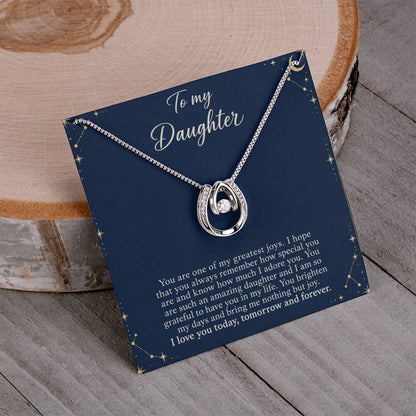 Lucky In Love teardrop necklace in white gold finish – Midnight Celestial necklace and message card on wood | Hensley London