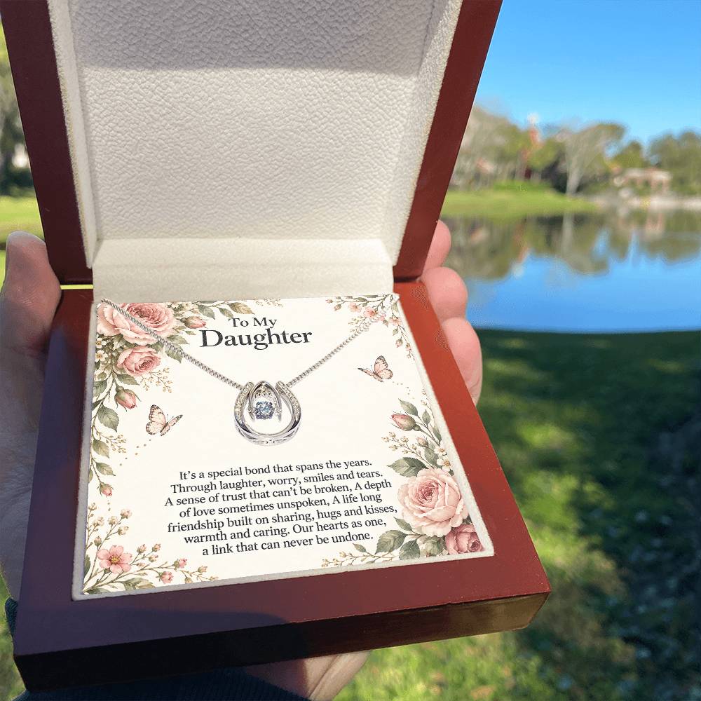 Lucky In Love teardrop necklace in white gold finish – Rose Botanical Luxury Box held outdoors | Hensley London