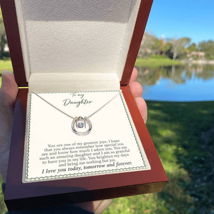 Lucky In Love teardrop necklace in white gold finish – Sage Gingham Luxury Box held outdoors | Hensley London