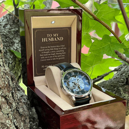 Black leather openwork watch for husband – open gift box among foliage | Hensley London