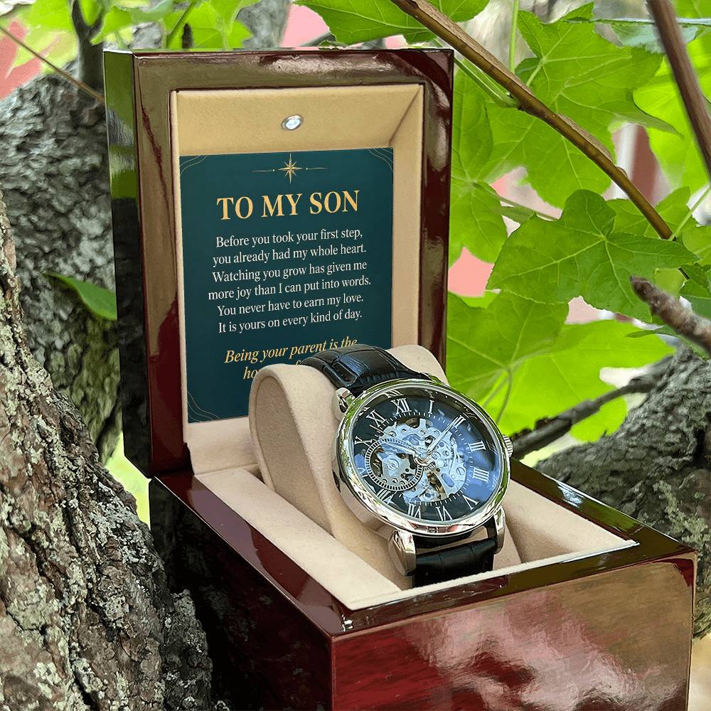 Black leather openwork watch for son – open gift box among foliage | Hensley London