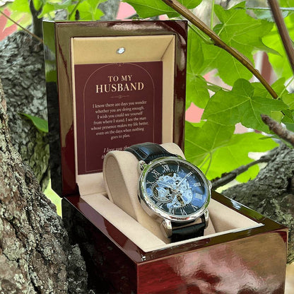 Black leather openwork watch for husband – open gift box among foliage | Hensley London