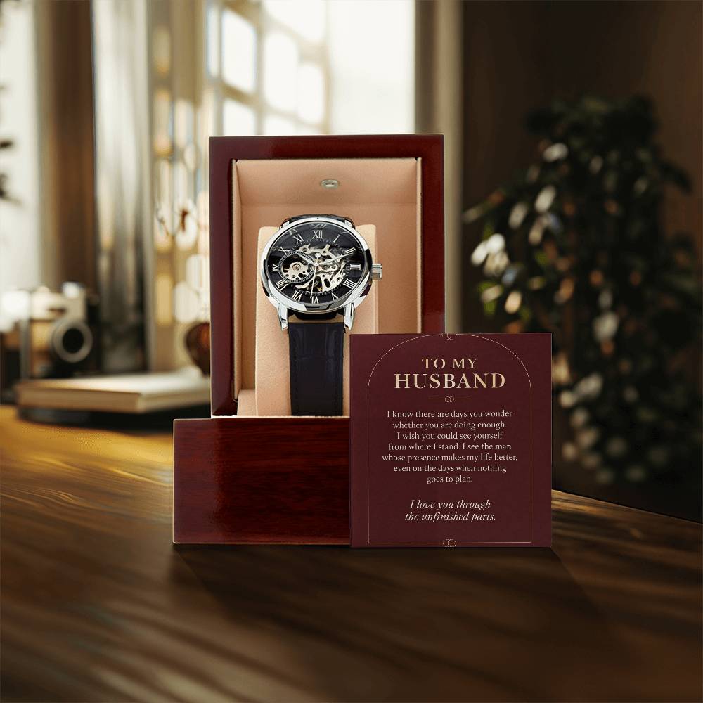 Black leather openwork watch for husband – gift box and message card on a tabletop | Hensley London