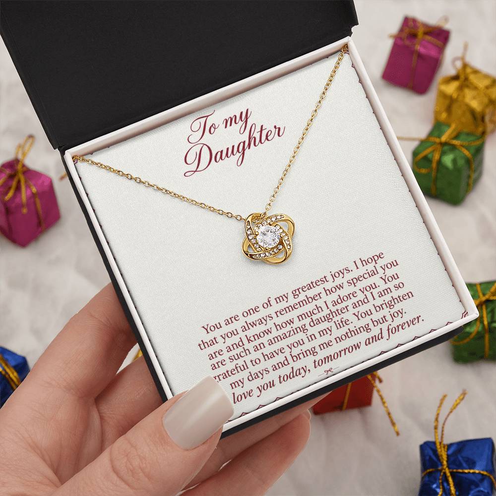 Love Knot necklace with Burgundy Letter daughter message card – yellow gold finish necklace in Standard Box held in hand | Hensley London