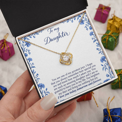 Love Knot necklace with Blue Porcelain daughter message card – yellow gold finish necklace in Standard Box held in hand | Hensley London
