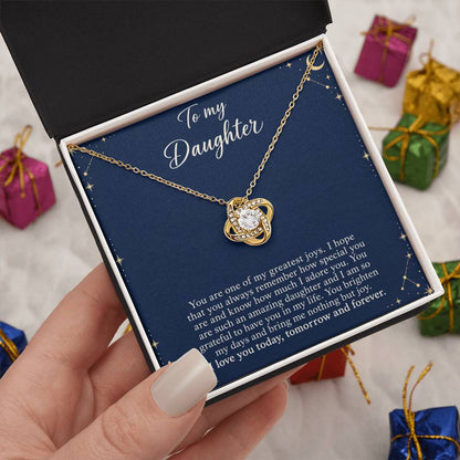Love Knot necklace with Midnight Celestial daughter message card – yellow gold finish necklace in Standard Box held in hand | Hensley London