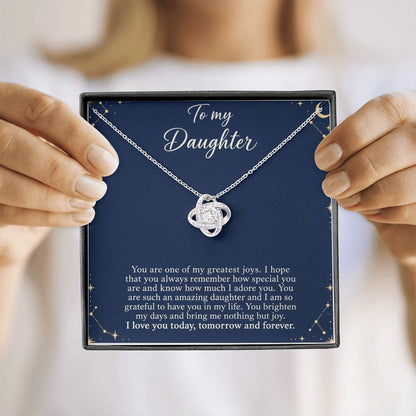 Love Knot necklace with Midnight Celestial daughter message card – white gold finish necklace in Standard Box held in hand | Hensley London