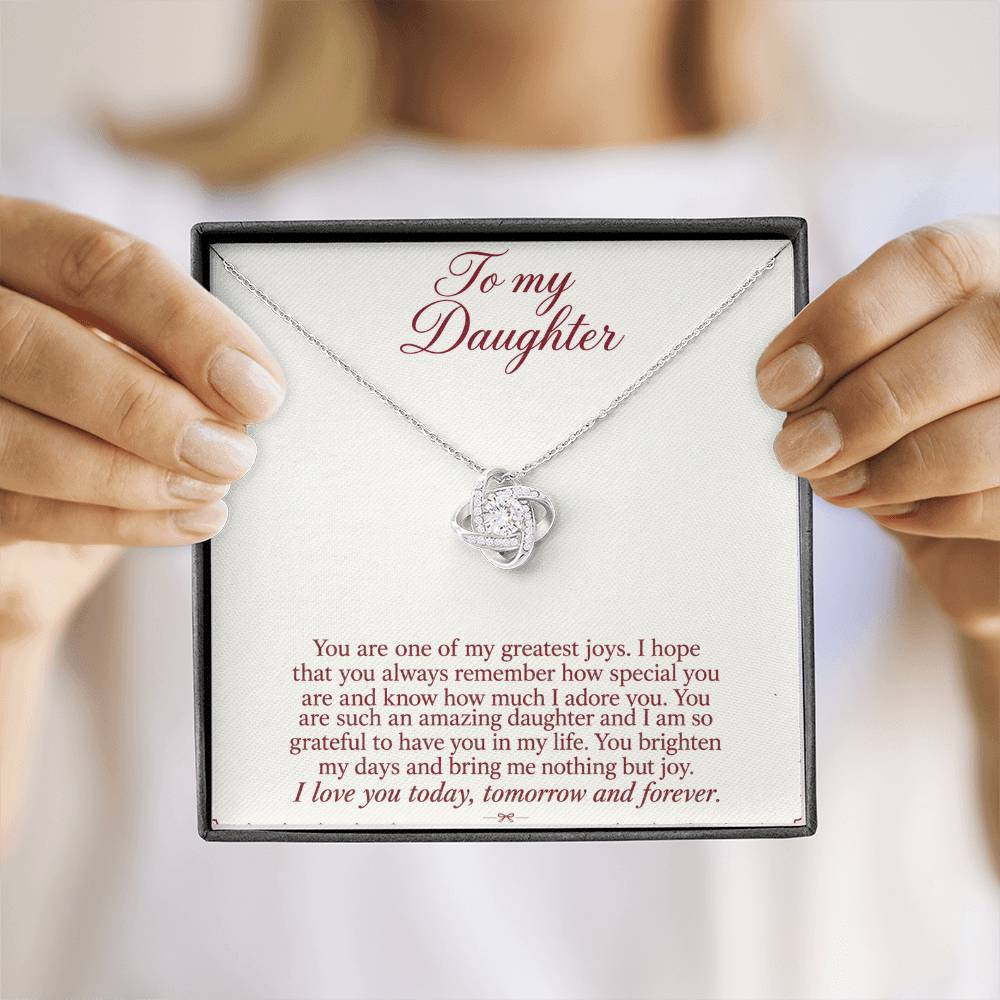 Love Knot necklace with Burgundy Letter daughter message card – white gold finish necklace in Standard Box held in hand | Hensley London
