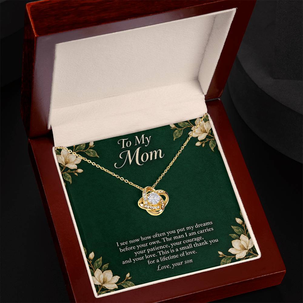 Yellow-gold Love Knot necklace and emerald Mom message card in open luxury box | Hensley London