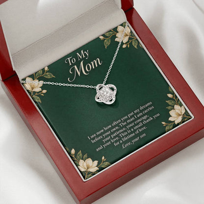 White-gold Love Knot necklace and emerald Mom message card in open luxury box | Hensley London