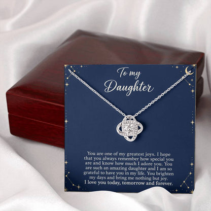 Love Knot necklace with Midnight Celestial daughter message card – white gold finish necklace and card beside Luxury Box | Hensley London