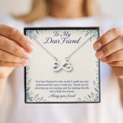 White-gold Endless Love infinity necklace and Friend message card held upright | Hensley London