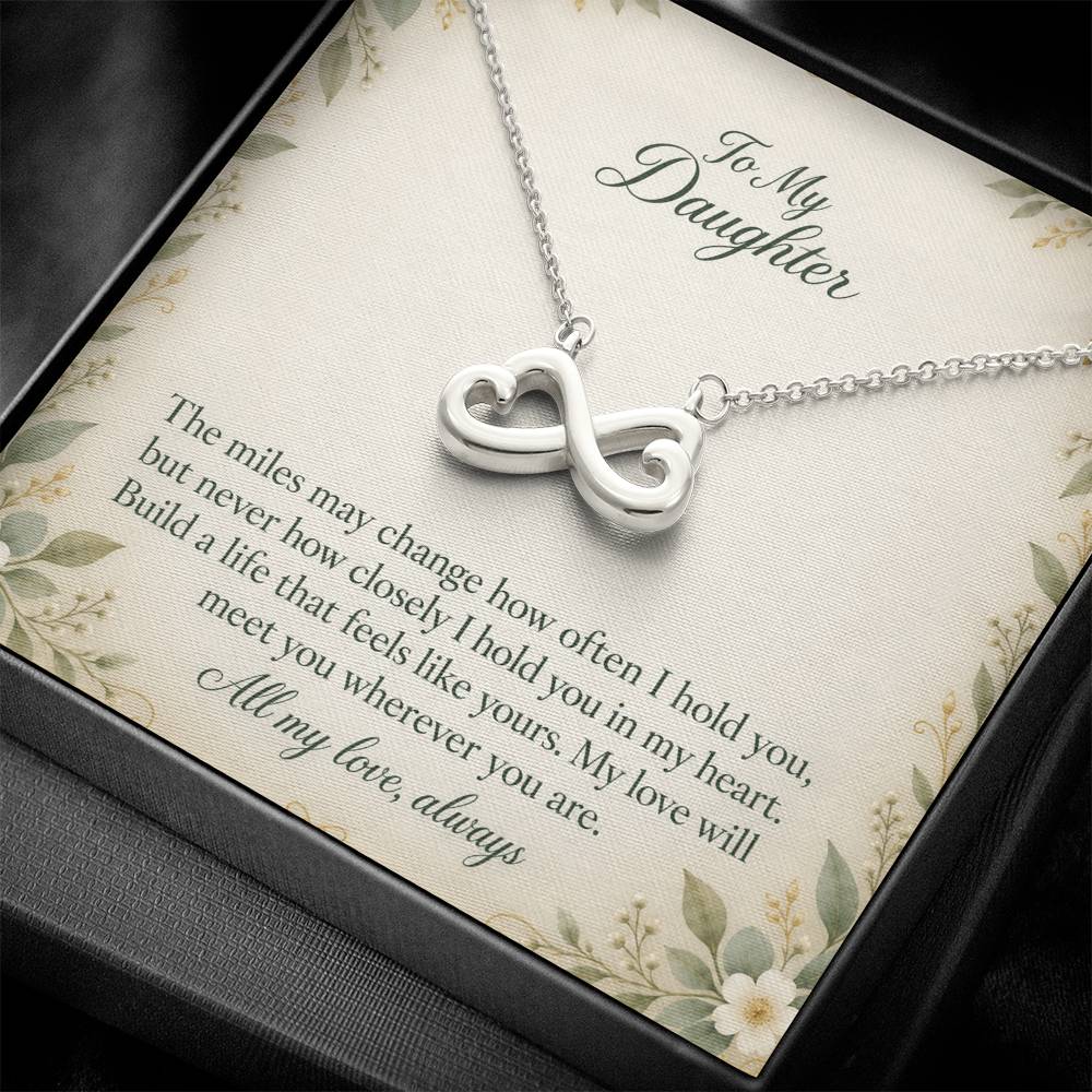White-gold Endless Love infinity necklace and floral Daughter message card in standard box, close view | Hensley London