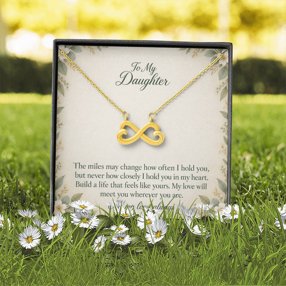 Yellow-gold Endless Love infinity necklace and Daughter message card in standard box outdoors | Hensley London
