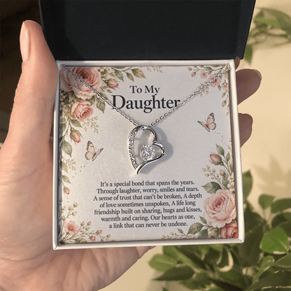 Gift for Daughter Forever Love Necklace in White Gold Finish – standard box held in hand | Hensley London