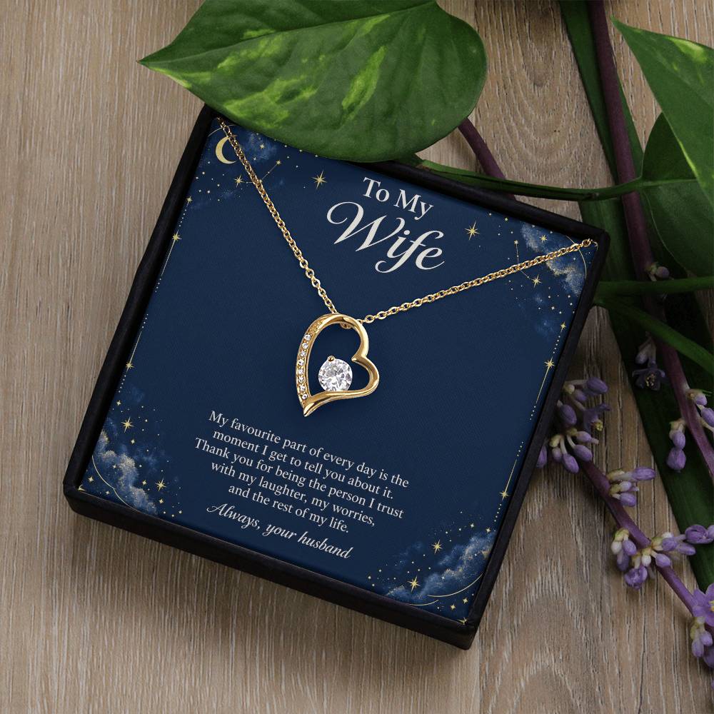 Yellow-gold Forever Love heart necklace and Wife message card in standard box beside leaves | Hensley London