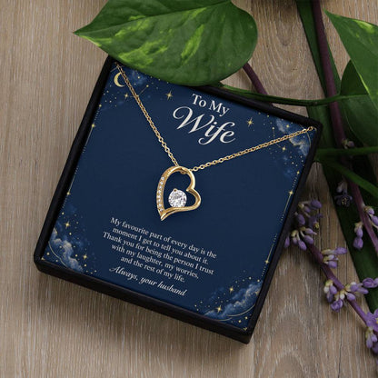 Yellow-gold Forever Love heart necklace and Wife message card in standard box beside leaves | Hensley London