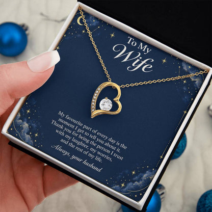 Yellow-gold Forever Love heart necklace and Wife message card in standard box held in hand | Hensley London