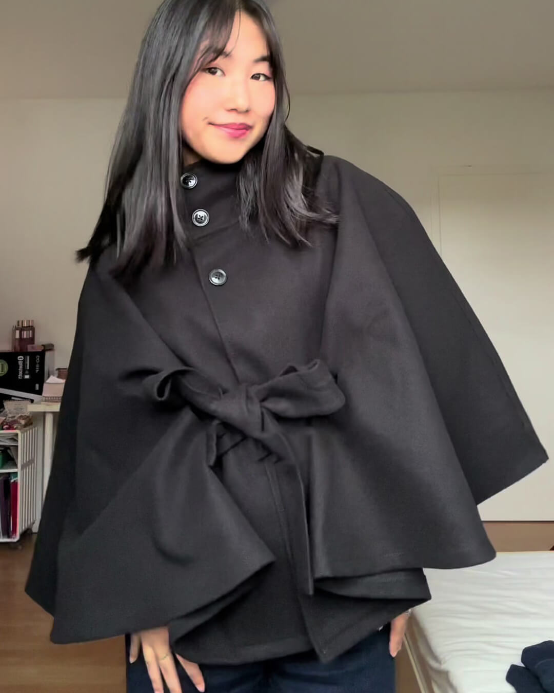 Women's High-Neck Belted Cape Jacket in Black - lifestyle view | Hensley London