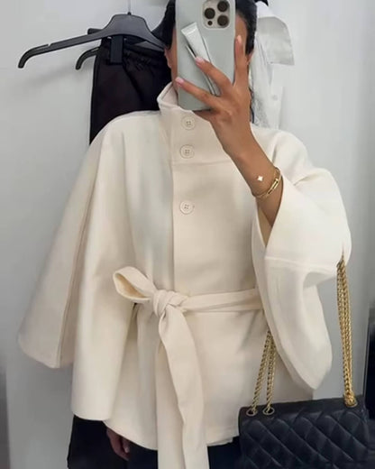 Women's High-Neck Belted Cape Jacket in White - lifestyle view | Hensley London