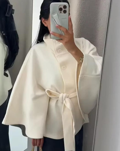 Women's High-Neck Belted Cape Jacket in White - lifestyle view | Hensley London