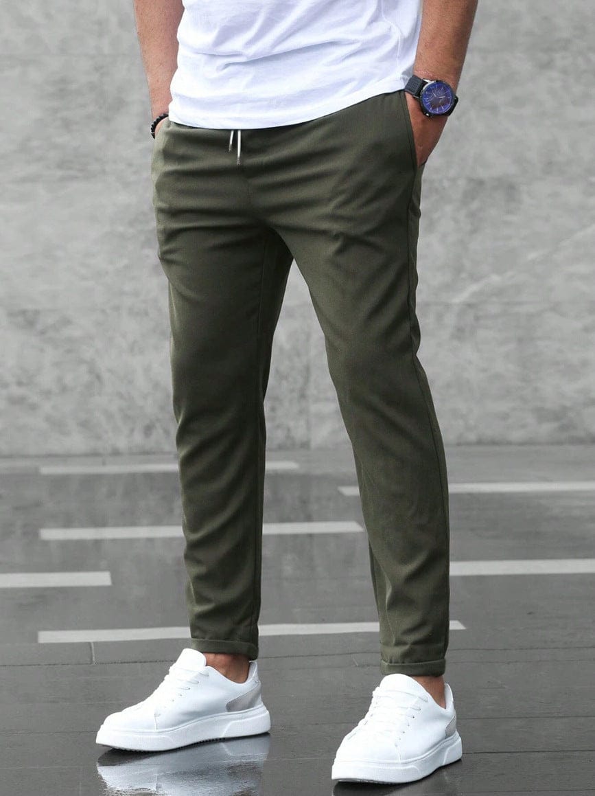 Men's Drawstring Tapered Trousers with Elasticated Waist in Green – front view on model | Hensley London