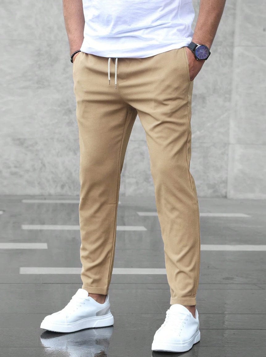 Men's Drawstring Tapered Trousers with Elasticated Waist in Khaki – front view on model | Hensley London