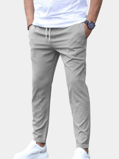 Men's Drawstring Tapered Trousers with Elasticated Waist in Gray – front view on model | Hensley London