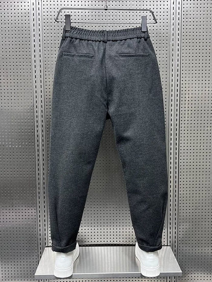 Men's Pleated Tapered Trousers with Belt Loops in Dark Gray – back view | Hensley London