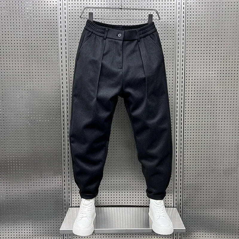 Men's Pleated Tapered Trousers with Belt Loops in Black – front view | Hensley London