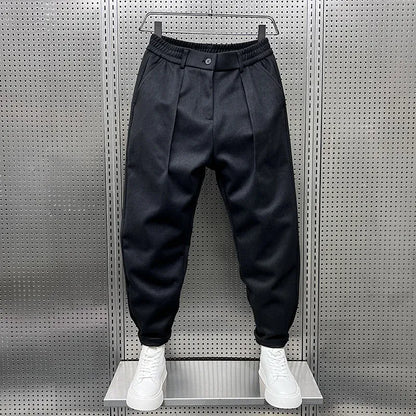Men's Pleated Tapered Trousers with Belt Loops in Black – front view | Hensley London